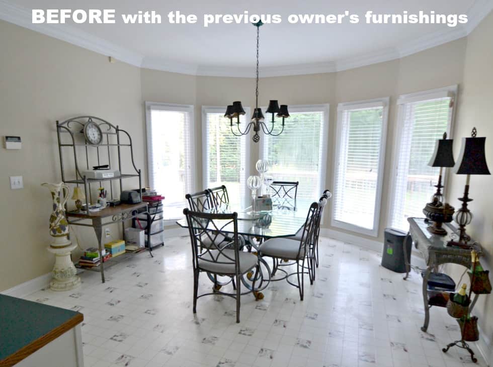 Breakfast Area Before The Makeover with white flooring and a small glass table.