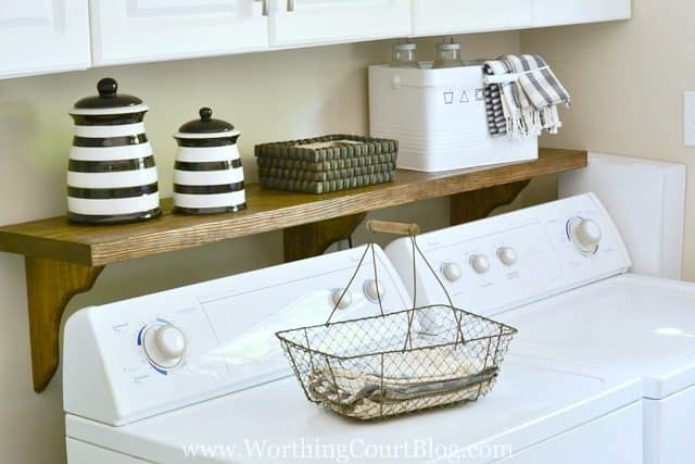 DIY shelf behind the washer and dryer to fill the gap behind the machines and to hold laundry supplies