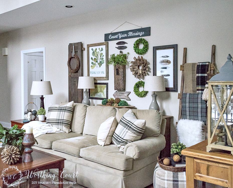 A rustic gallery wall behind the sofa in the living room.