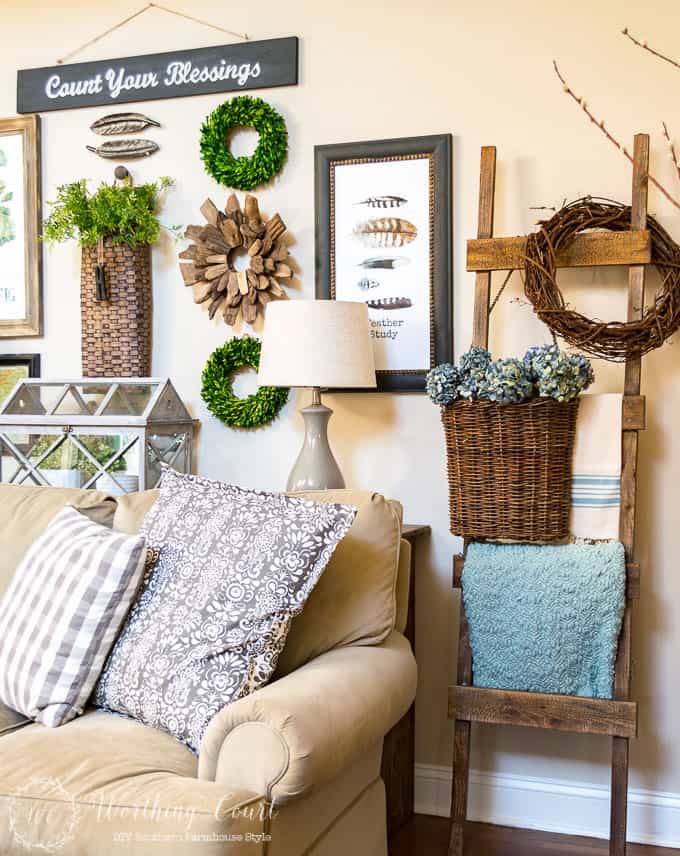 Lighten up a rustic ladder for spring with a pretty blue throw and some dried hydrangeas in hanging basket.