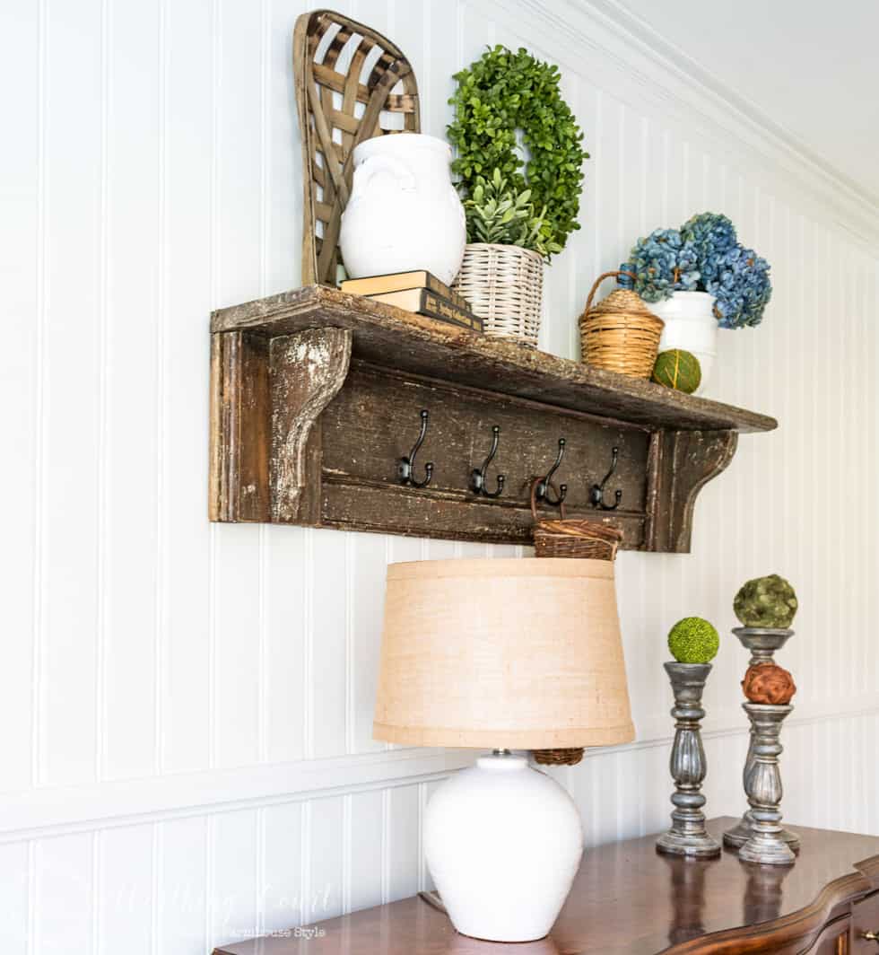 A wooden shelf on the shiplap wall.