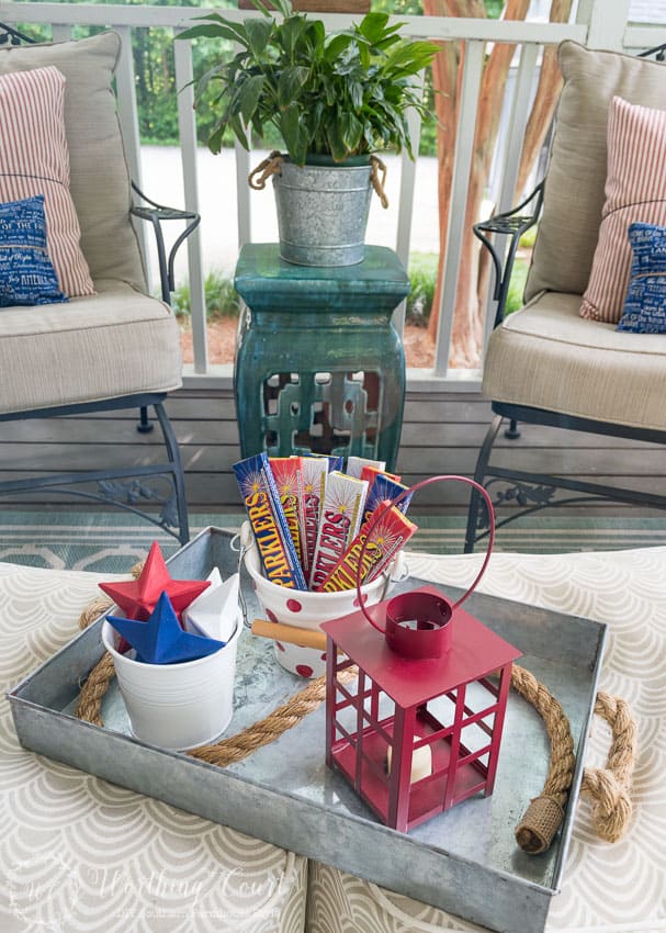 A farmhouse porch filled with loads of red, white and blue vintage Americana patriotic decorating ideas for Memorial Day, Flag Day and July 4th.