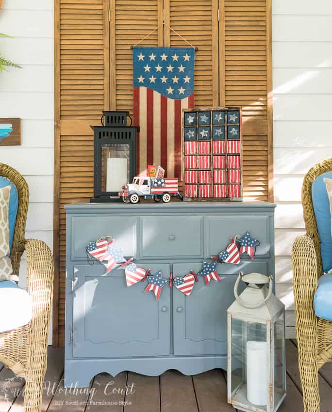 A farmhouse porch filled with loads of red, white and blue vintage Americana patriotic decorating ideas for Memorial Day, Flag Day and July 4th. 