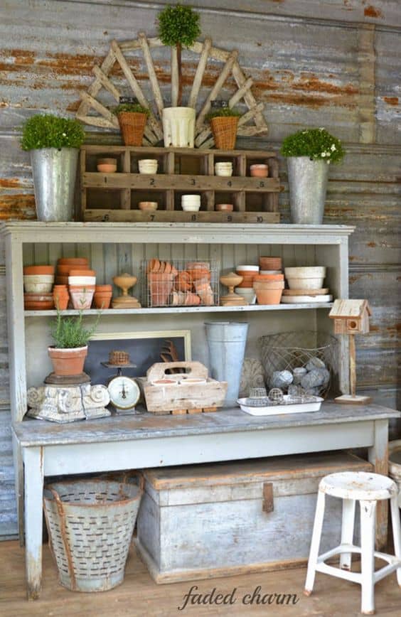 The terra cotta pots being used as decorative accessories on open rustic shelves.