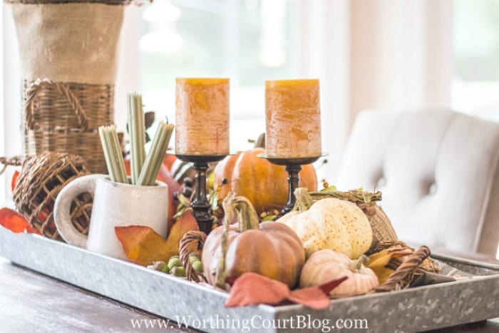 When determining how to make a centerpiece, remember that if you are going display your centerpiece in a tray with sides, you'll need to use tall items or else elevate the smaller ones. #falldecor #howto #tips || Worthing Court