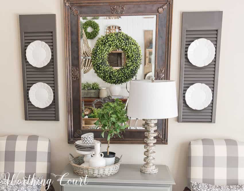 Farmhouse Dining Room Makeover - a mirror in a dark room adds a bit of light and relfect the pretty vignette across from it