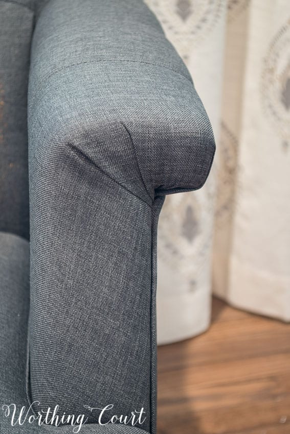 Gray tufted arm chair from Hayneedle arm detail