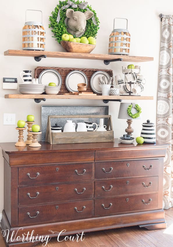 Open rustic farmhouse kitchen shelves decorated for late summer