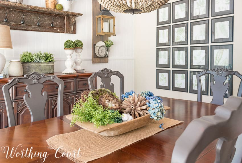 Wooden dough bowl filled with spring decor in the dining room.