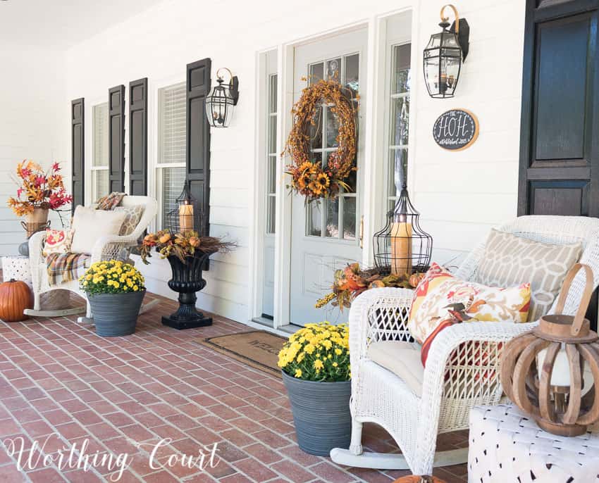 Fall front porch with wicker rockers and fall urns || Worthing Court