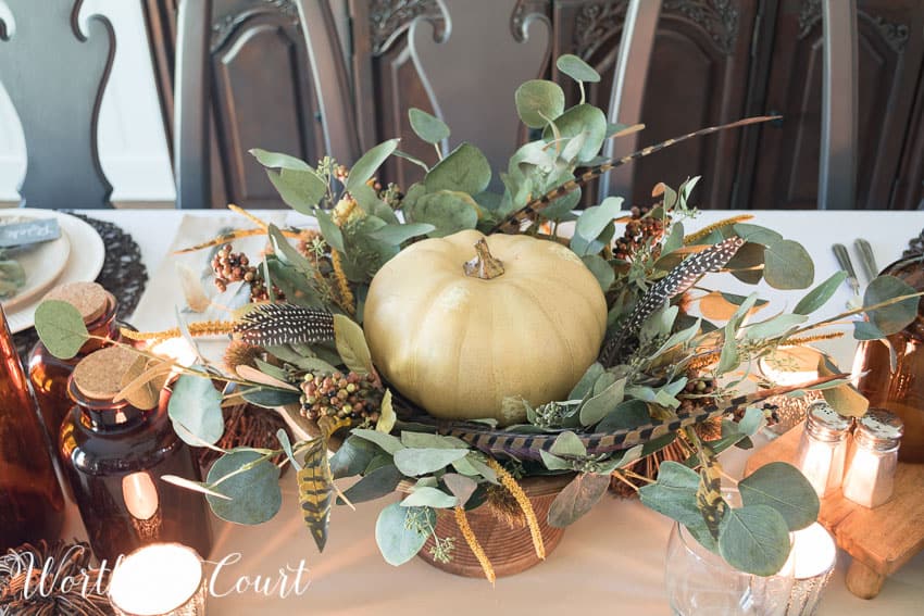 Thanksgiving centerpiece using a faux pumpkin, eucalyptus leaves and feathers || Worthing Court