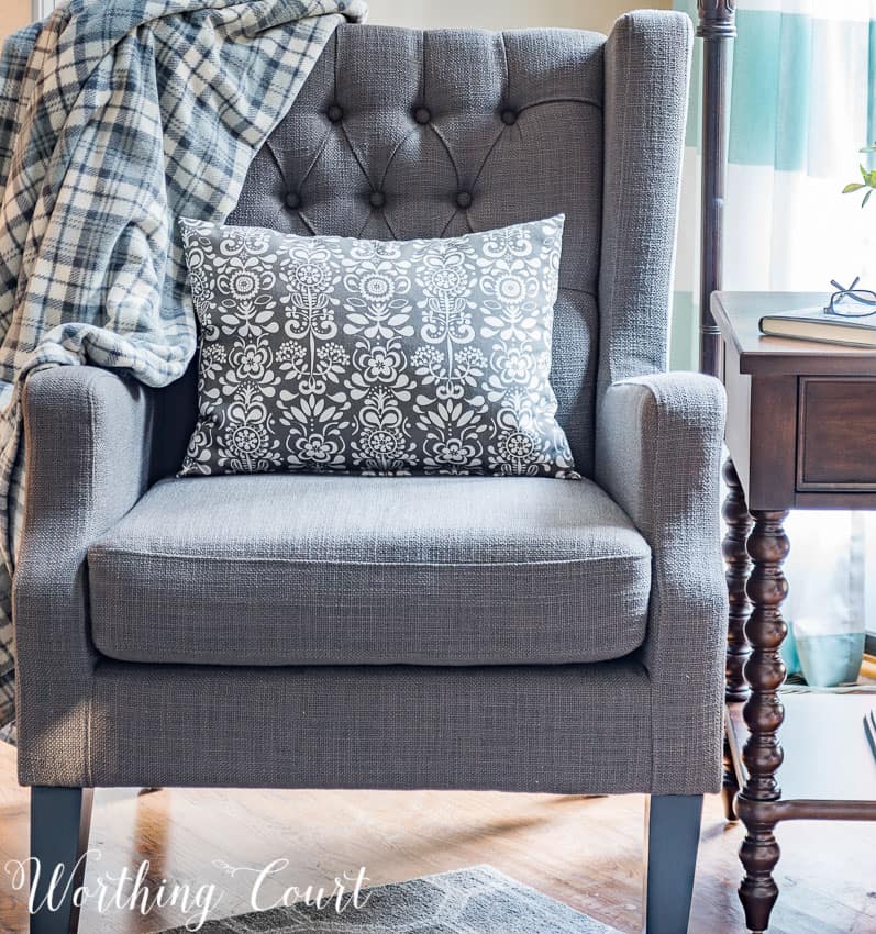 Gray wing chair with tufted back || Worthing Court