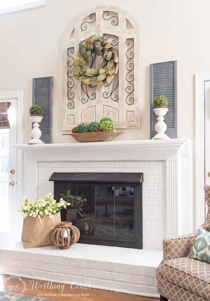 Farmhouse style white painted brick fireplace and mantel decorated for spring || Worthing Court