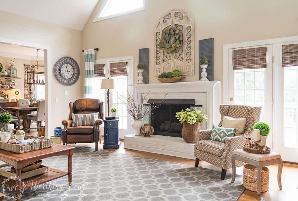 Farmhouse style white painted brick fireplace and mantel decorated for spring || Worthing Court