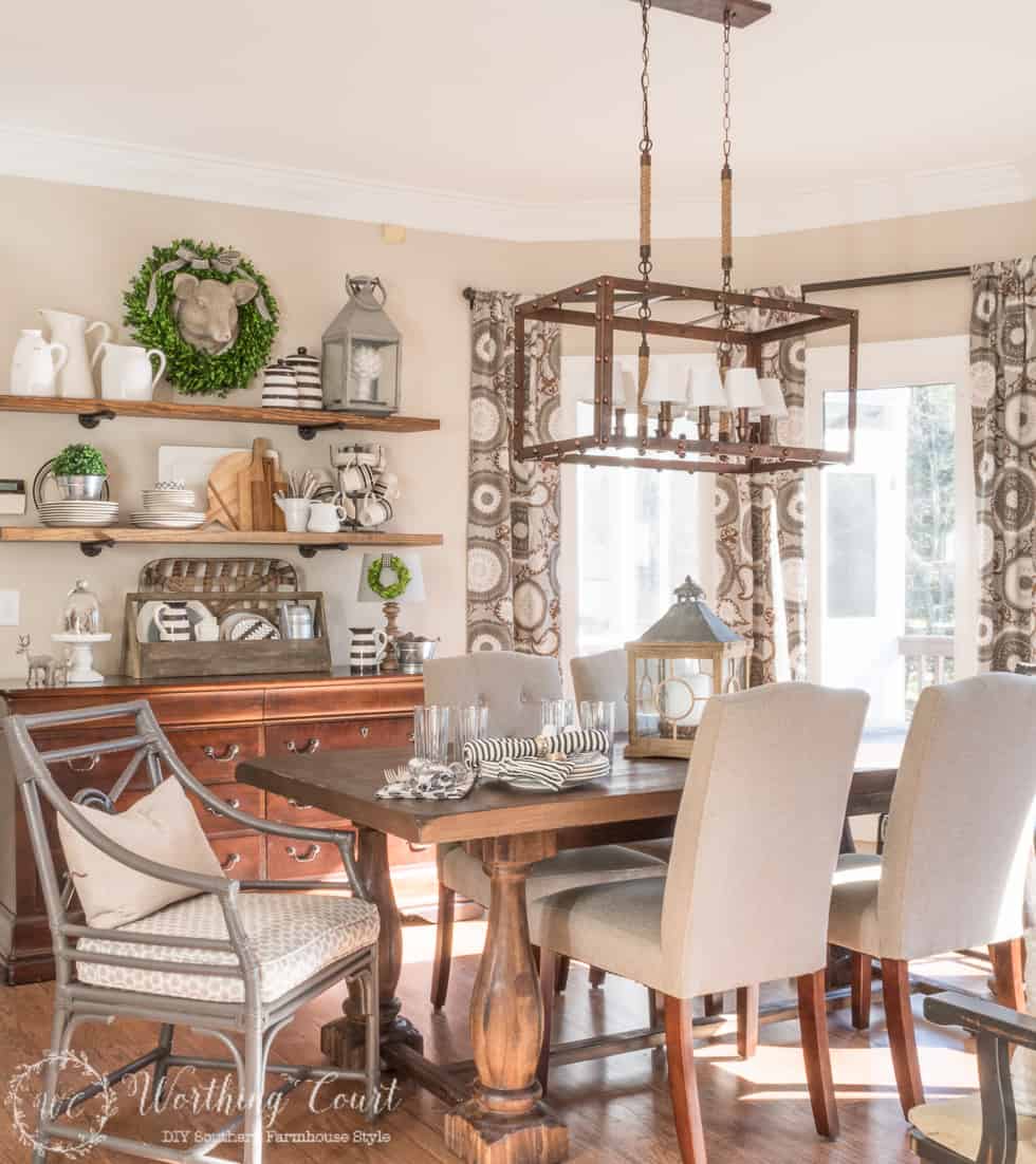 breakfast room with farmhouse table, gray chairs and rustic open shelves