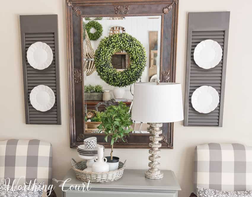 Farmhouse Dining Room Makeover - a mirror in a dark room adds a bit of light and relfect the pretty vignette across from it || Worthing Court