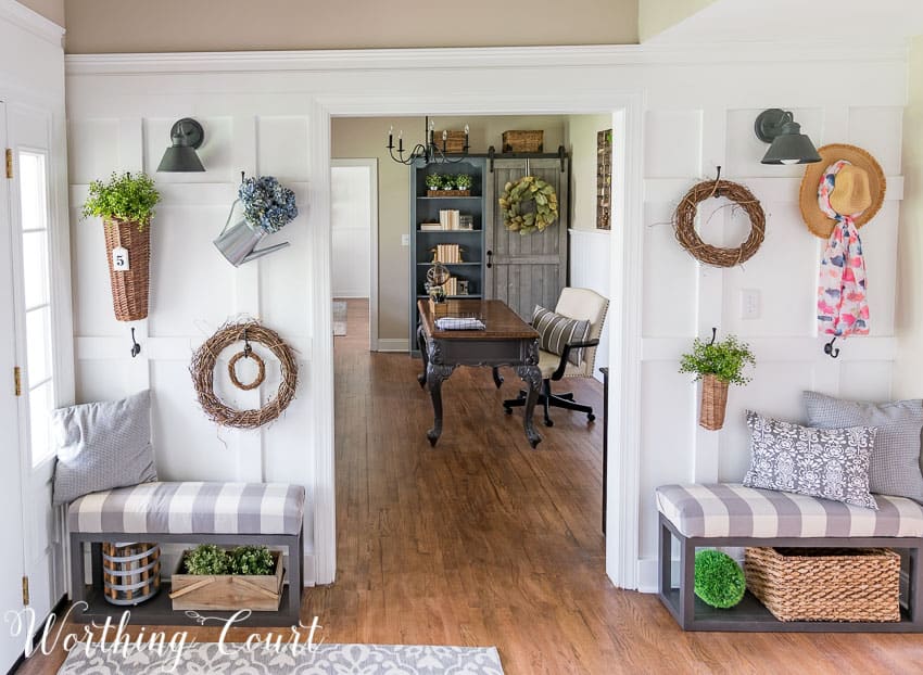 Fill a board and batten wall with baskets, grapevine wreaths and greenery to create a farmhouse feel || Worthing Court
