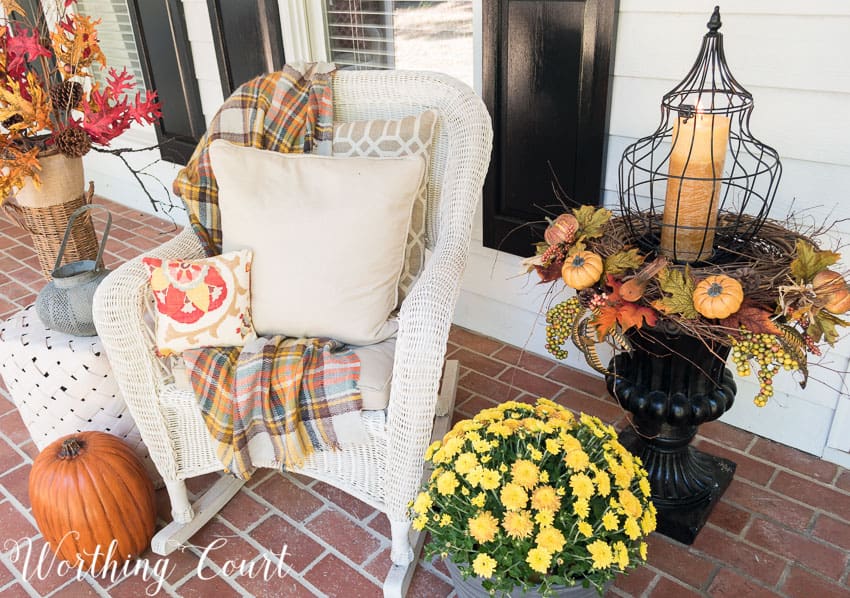 fall porch decorations with a rocking chair and decorated urn