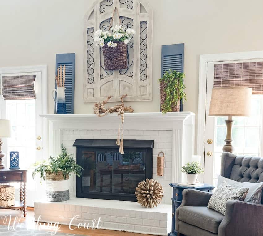Farmhouse style painted brick fireplace decorated with simple and organic elements for the summer || Worthing Court