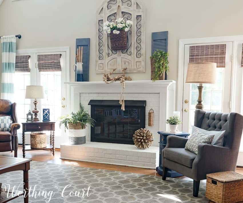 Farmhouse style painted brick fireplace decorated for summer || Worthing Court