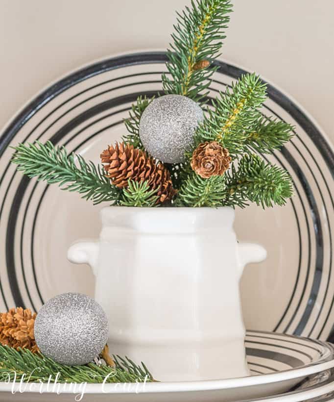 small white stoneware container with winter greens