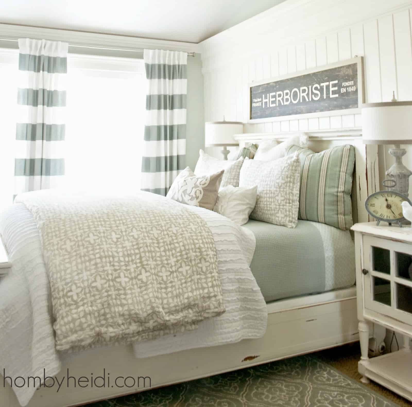 Great Tips for how to add style to a small bedroom. If you must have patterned bedding, keeping it subtle and not overly large will cut down on the busy look. This is a wonderful mix of patterns, solids and colors.