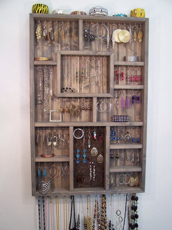 Loads of tips for how to add style to a small bedroom. A shadow box jewelry organizer not only stores your jewelry, but serves as a piece of art too.