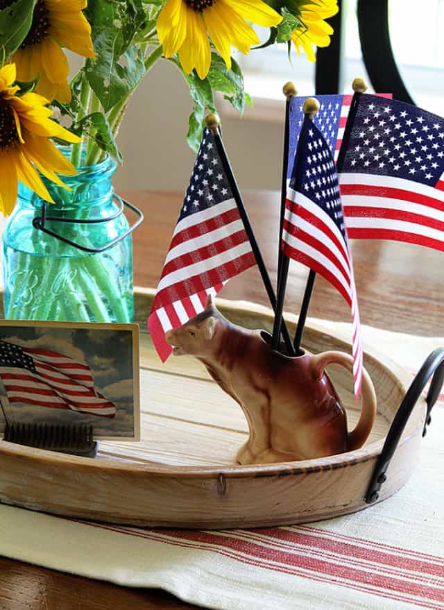 round wood tray with American flags in a pitcher