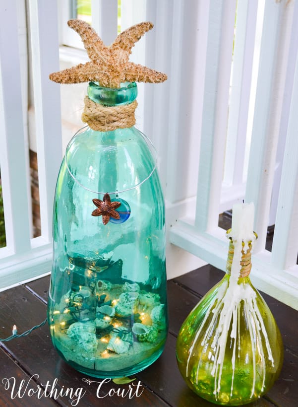 Colored glass with a starfish and seashells inside the glass decoration.
