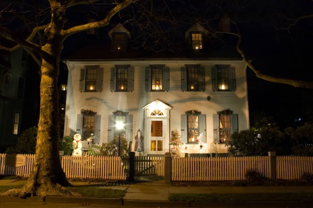 two story house at night with lights on