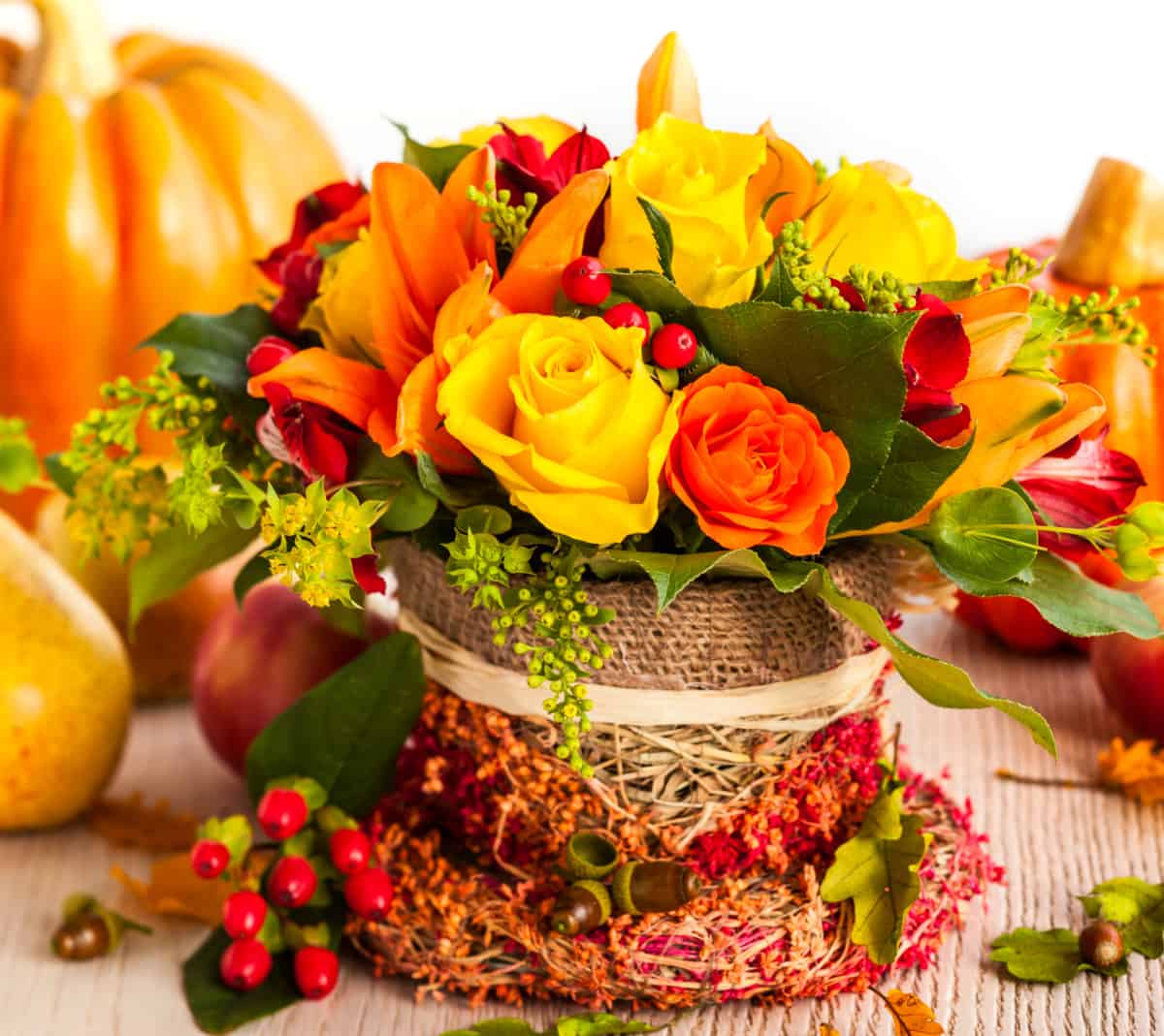 Floral arrangement using yellow and orange roses for a Thanksgiving centerpiece