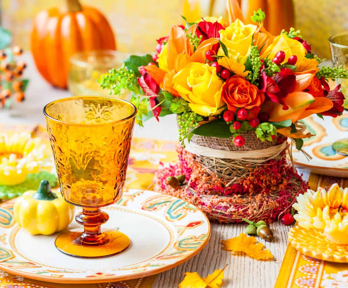 Floral arrangement using yellow and orange roses for a Thanksgiving centerpiece