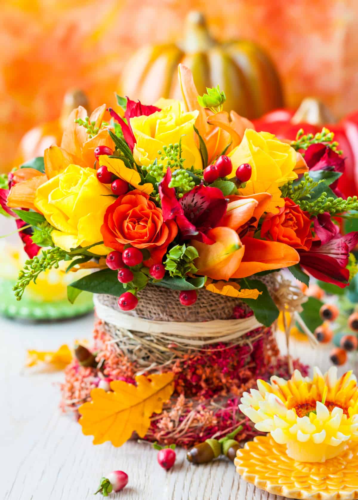 Floral arrangement using yellow and orange roses for a Thanksgiving centerpiece