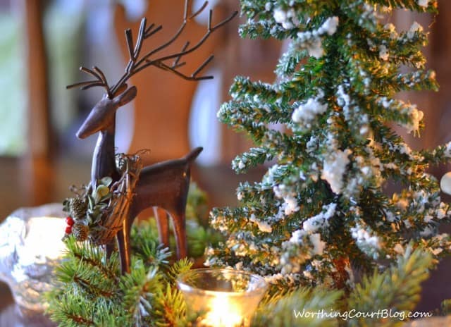 A small wooden reindeer in the centerpiece.