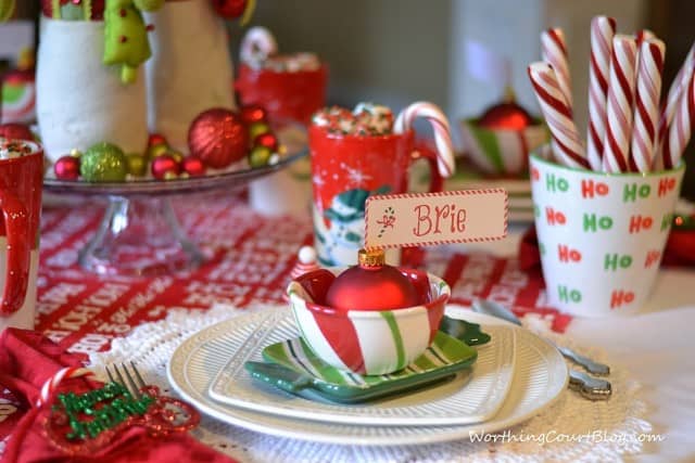 There are candy canes in a cup on the table.