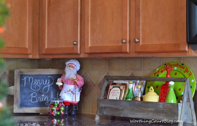  Christmas vignette in my kitchen with a wooden toolbox, cooking Santa and a chalkboard.