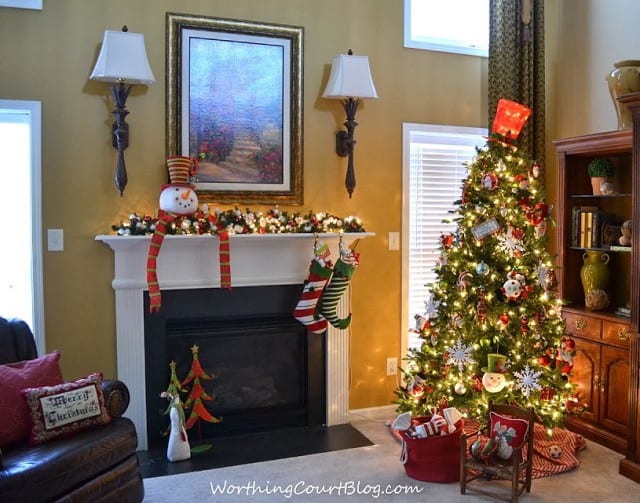 Christmas tree and mantel with stockings hanging from the fireplace.