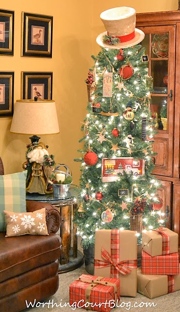 Rustic Christmas tree with wrapped presents underneath.