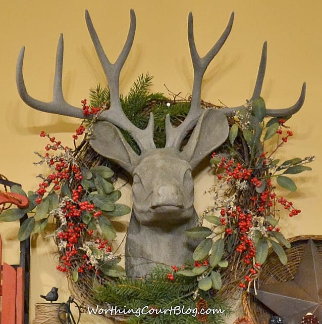  Faux deer head with a Christmas wreath.