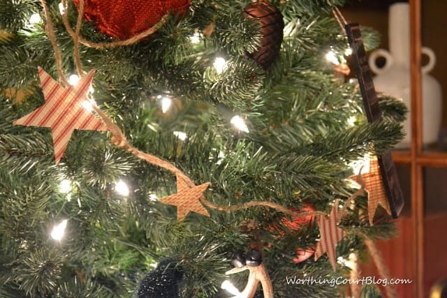 The star garland on the tree with white lights.