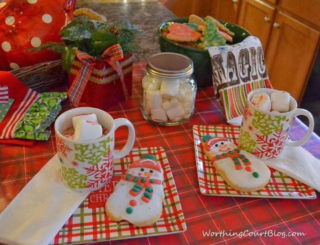  Hot cocoa and cookie table using products from Dollar General with marshmallows and cookies on a plate.