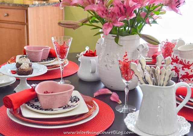 There are treats on a white cake stand.