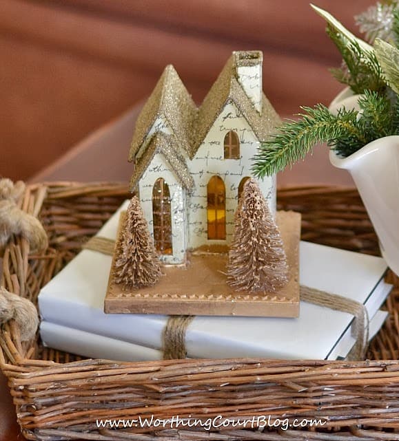  Paper church displayed on books wrapped with white paper and tied with twine