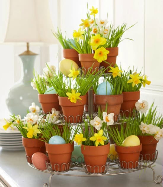 Mini pots displayed on a tiered cupcake stand are a great way to display spring flowers.