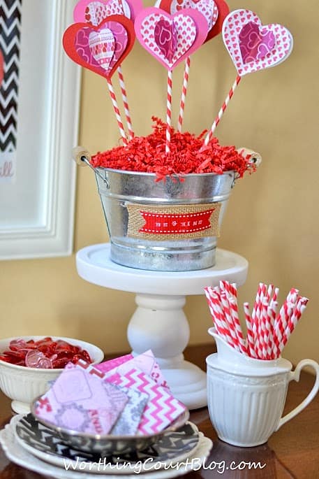 Valentine's vignette with a bucket full of heart flowers.