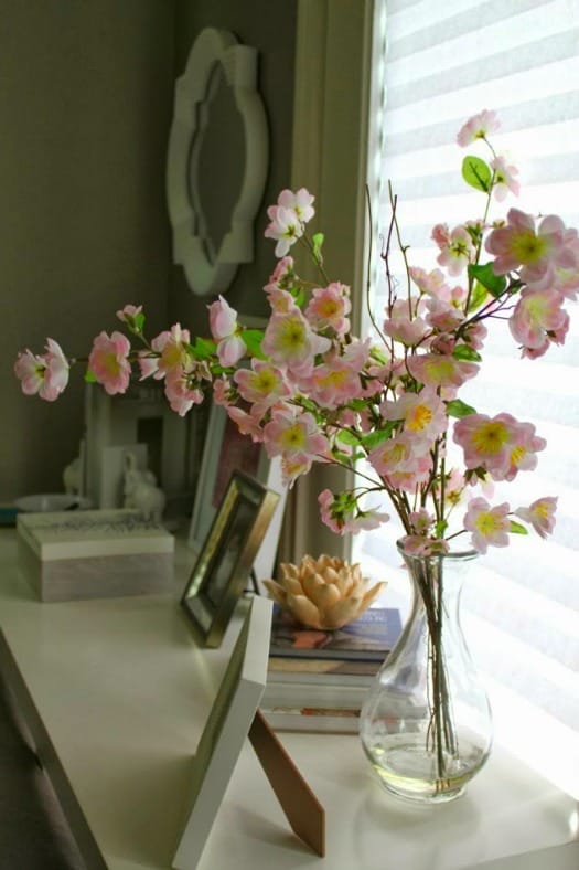 A single glass vase filled with cherry tree blossoms makes a lovely display of spring flowers.