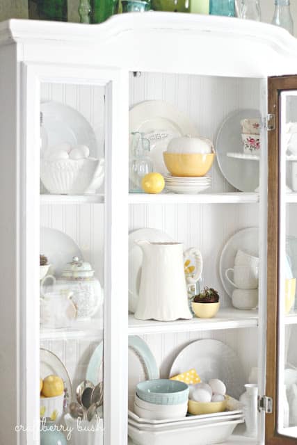 A white cabinet with pops of yellow in it.