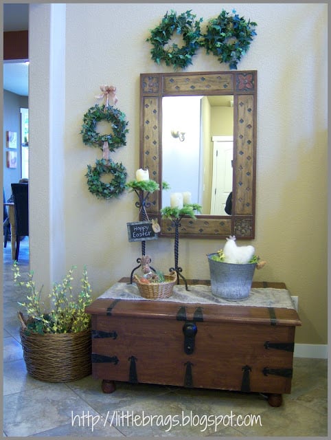 A wooden chest that has spring decor on top of it.