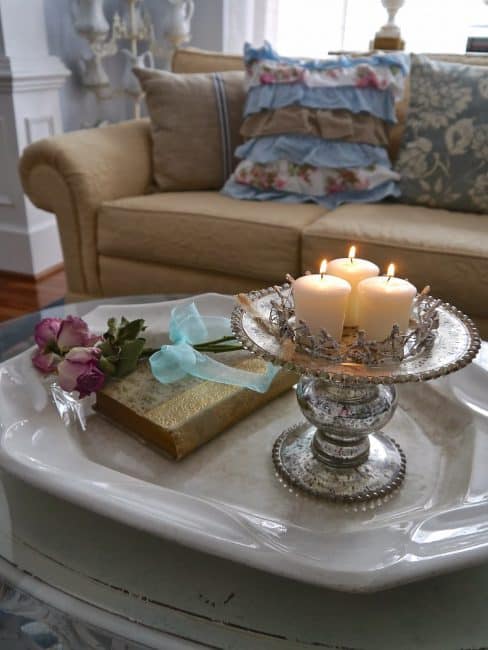 Candles are on a cake stand.