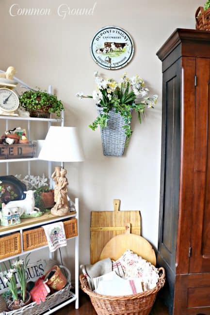 A basket is on the ground filled with French linen.